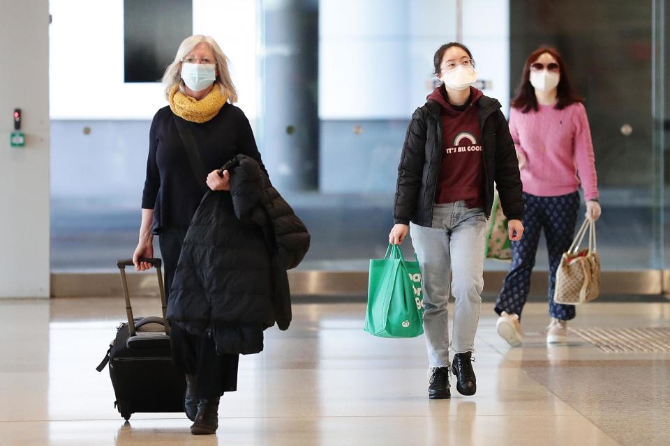 Passengers off a Melbourne to Sydney flight arrive at Sydney domestic airport on Tuesday ahead of the border closure (Getty Images)