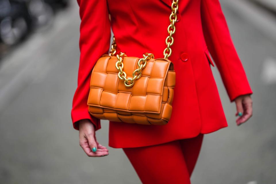 <p>I can't get enough of a metallic chain embellishing an otherwise regular shoulder bag. Bonus if it also has texture like this orange quilted style. One thing we can thank Daniel Lee for is the slew of <a href="https://www.popsugar.com/fashion/photo-gallery/46581362/image/46581380/For-pop-color-style-belted-blazer-with-shorts-bright" class="link rapid-noclick-resp" rel="nofollow noopener" target="_blank" data-ylk="slk:expertly designed bags">expertly designed bags</a> he created during his short tenure at Bottega Veneta. His intricate play on leather has gone on to inspire tens of thousands of iterations, pushing bag retailers to include the magcal details that definitely set shoulder bags apart from the rest.</p>