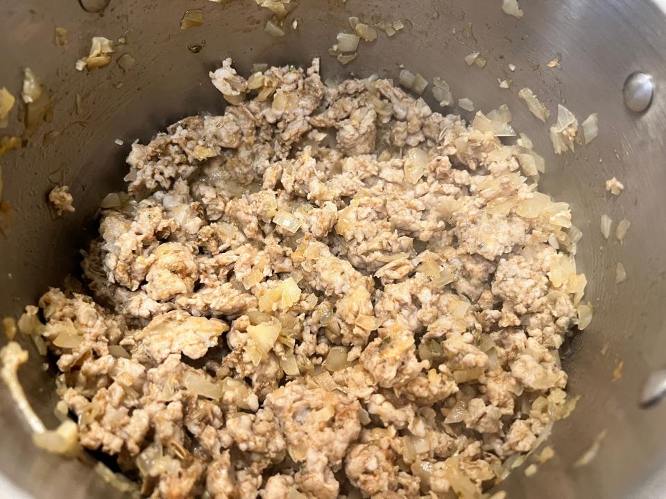 Ground chicken and spices in pot