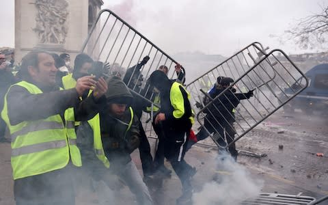 Thousands of anti-government protesters are expected today on the Champs-Elysees in Paris - Credit: AFP