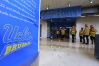 Firefighters enter Pauley Pavillion on the UCLA campus, which was flooded by a broken thirty inch water main in the Westwood section of Los Angeles July 29, 2014. The 100-year old water main flooded parts of the campus and stranded motorists on surrounding streets. REUTERS/Jonathan Alcorn