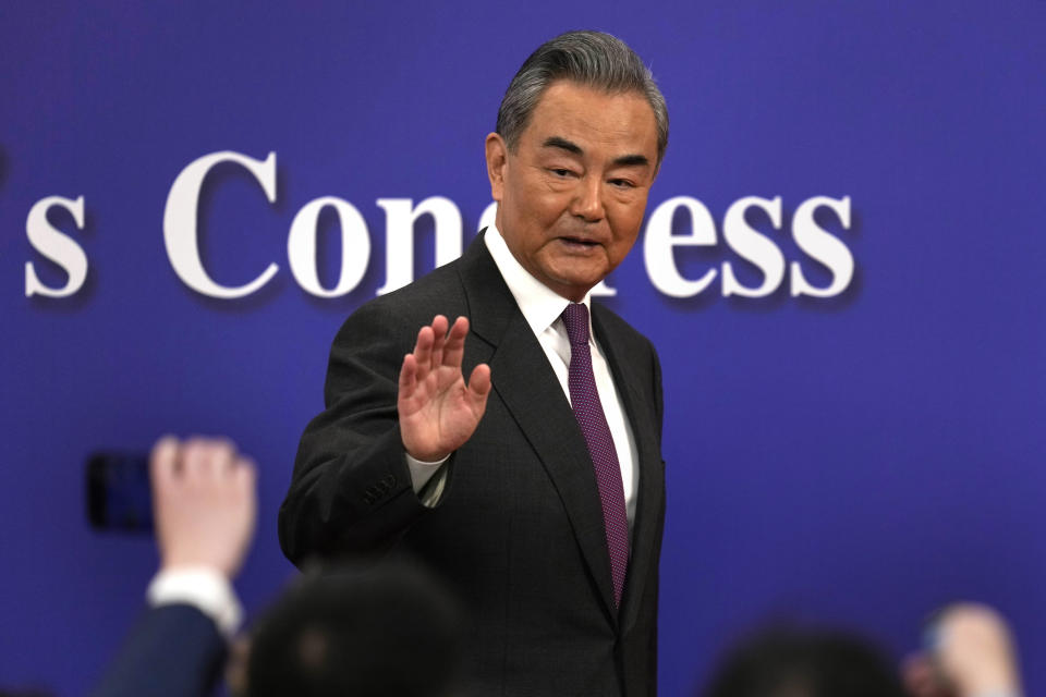 Chinese Foreign Minister Wang Yi waves as he leaves a press conference on the sideline of the National People's Congress in Beijing, Thursday, March 7, 2024. (AP Photo/Ng Han Guan)