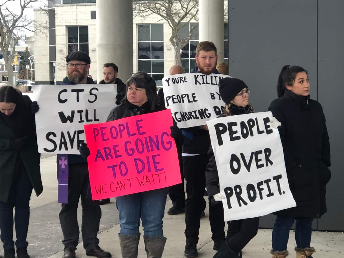 Community members held signs in support of the CTS site coming to downtown Windsor. (Darrin Di Carlo/CBC - image credit)