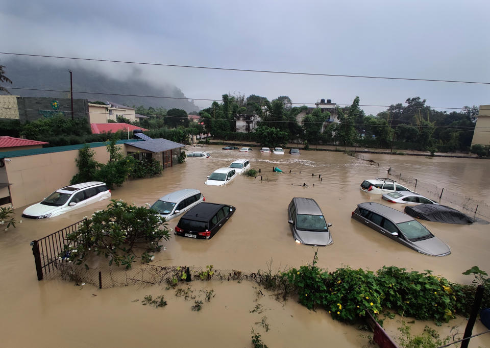 Submerged cars are seen at a flooded hotel resort as extreme rainfall caused the Kosi River to overflow at the Jim Corbett National Park in Uttarakhand, India, Tuesday, Oct. 19, 2021. More than 20 people have died and many are missing in floods triggered by heavy rains in the northern Indian state of Uttarakhand, officials said Tuesday. (AP Photo/Mustafa Quraishi)