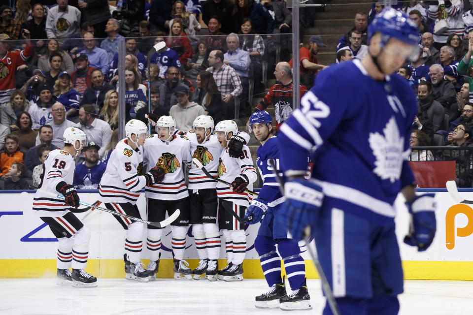Chicago Blackhawks centre Drake Caggiula (91) celebrates his goal with teammates during first period NHL hockey action against the Toronto Maple Leafs, in Toronto, Saturday, Jan. 18, 2020. (Cole Burston/The Canadian Press via AP)