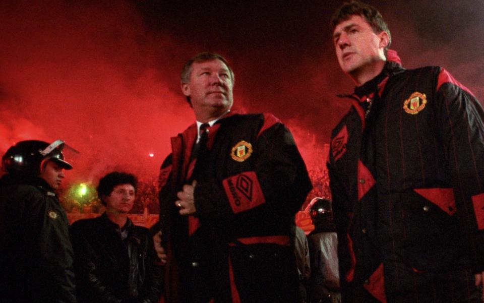 Manchester United manager Alex Ferguson (left) and his assistant Brian Kidd arrive on to the pitch at Ali Sami Yen Stadium - 'Welcome to Hell' 30 years on: The night Man United took on Galatasaray — and Turkish riot police