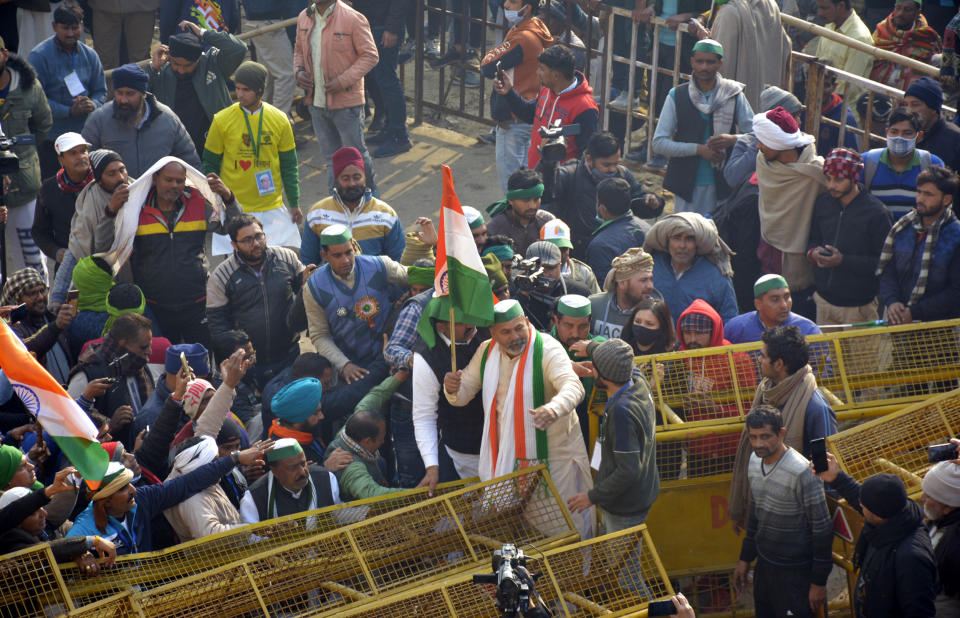 NEW DELHI, INDIA - JANUARY 26: Bharatiya Kisan Union (BKU) leader Rakesh Tikat among demonstrators breaking past police barricades while heading into the capital during a tractor rally on Republic Day, at Ghazipur on January 26, 2021 in New Delhi, India. Major scenes of chaos and mayhem at Delhi borders as groups of farmers allegedly broke barricades and police check posts and entered the national capital before permitted timings. Police used tear gas at Delhi's Mukarba Chowk to bring the groups under control. Clashes were also reported at ITO, Akshardham. Several rounds of talks between the government and protesting farmers have failed to resolve the impasse over the three farm laws. The kisan bodies, which have been protesting in the national capital for almost two months, demanding the repeal of three contentious farm laws have remained firm on their decision to hold a tractor rally on the occasion of Republic Day. (Photo by Sakib Ali/Hindustan Times via Getty Images)