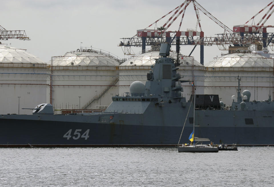 People on a yacht, right, protest against the Russian frigate Admiral Gorshkov docked in the Cape Town harbour South Africa, Tuesday, Feb. 14, 2023 en route to the South African east coast to conduct naval exercises with the South African and Chinese Navy. The exercise is set to begin Friday Feb. 17, 2023, a demonstration of the countries' close ties amid Russia's war in Ukraine and China's tense relationship with the West. (AP Photo/Nardus Engelbrecht)