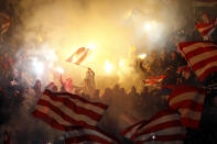 Red Star fans light flares as they cheer for their team during their Serbian Superleague soccer match against Partizan Belgrade in Belgrade, November 17, 2012. REUTERS/Marko Djurica (SERBIA - Tags: SPORT SOCCER TPX IMAGES OF THE DAY)