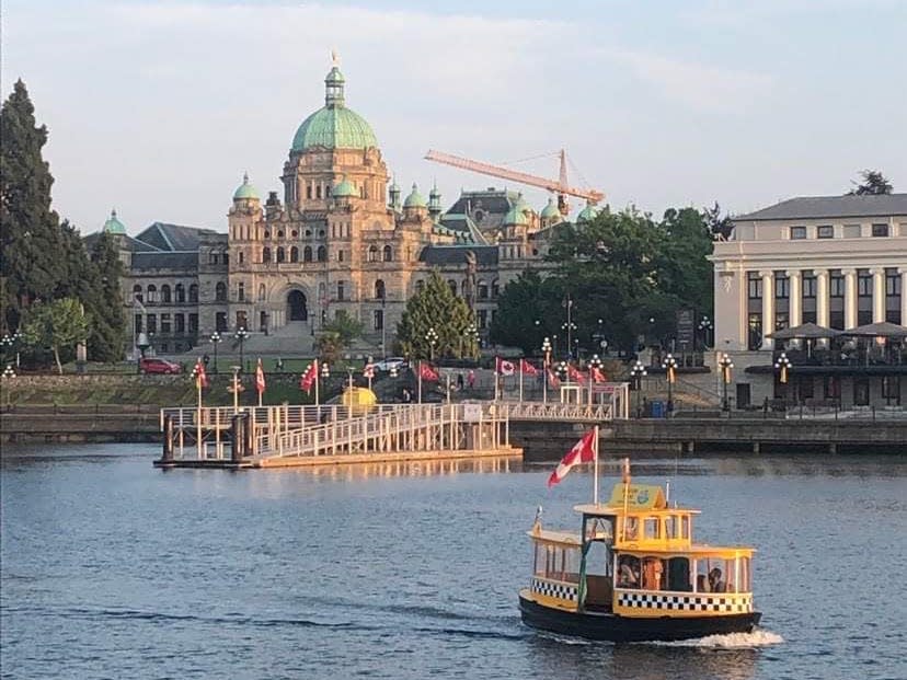view of the city and municipal buildings on the other side of a waterway in victoria canada