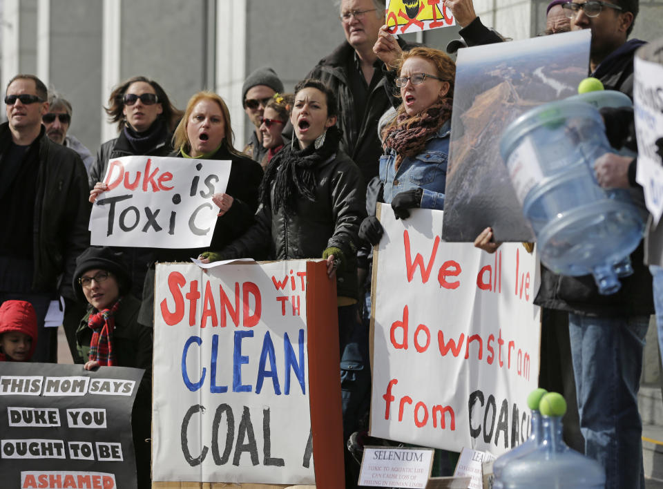 Demonstrators hold signs and chant during a protest near Duke Energy's headquarters in Charlotte, N.C., Thursday, Feb. 6, 2014 over Duke Energy's coal plants. Duke Energy estimates that up to 82,000 tons of ash has been released from a break in a 48-inch storm water pipe at the Dan River Power Plant on Sunday. (AP Photo/Chuck Burton)