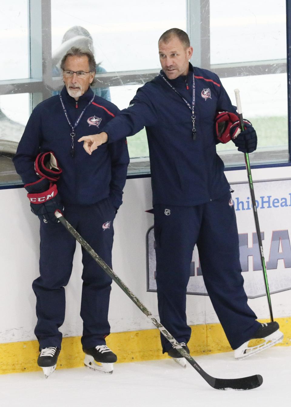 Columbus Blue Jackets head coach John Tortorella, left, and assistant coach Brad Larsen, right, chat during postseason training camp on Monday, July 13, 2020 at the OhioHealth Ice Haus in Columbus, Ohio. [Joshua A. Bickel/Dispatch]