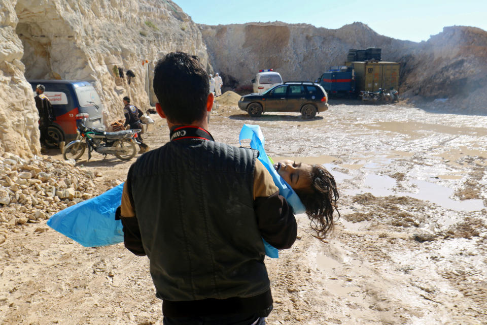 A man carries the body of a dead child, after what rescue workers described as a suspected gas attack in the town of Khan Sheikhoun in rebel-held Idlib, Syria on April 4, 2017.