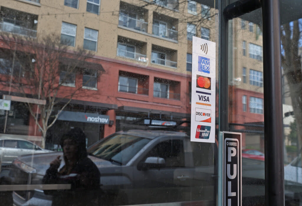 credit card decal is displayed on the window of a business