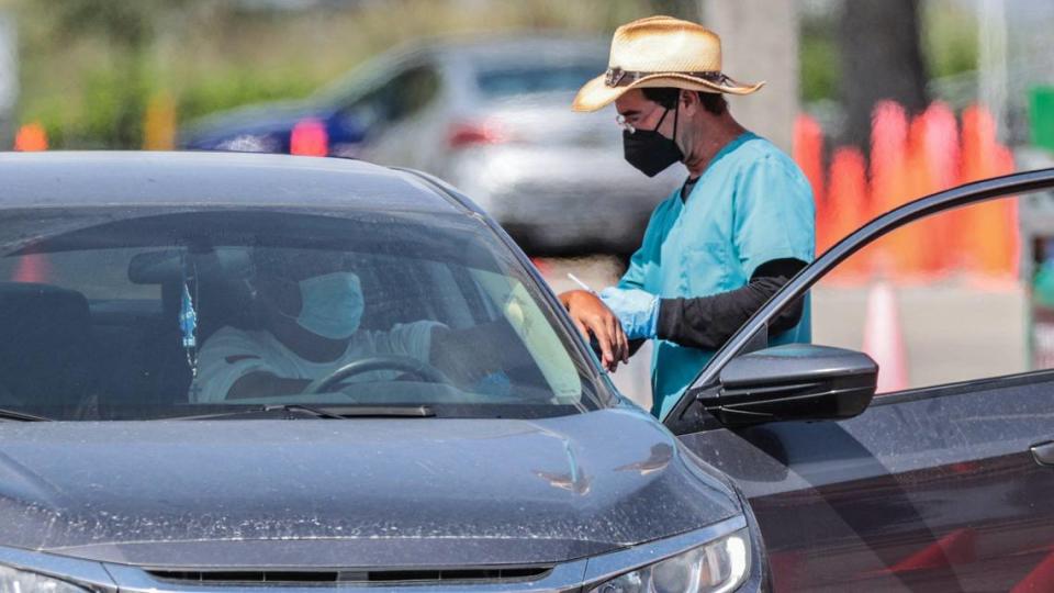 A person prepares to be vaccinated at the Miami-Dade County COVID-19 Community-Based Testing & Vaccination Site at Tropical Park in this October 2021 file photo.