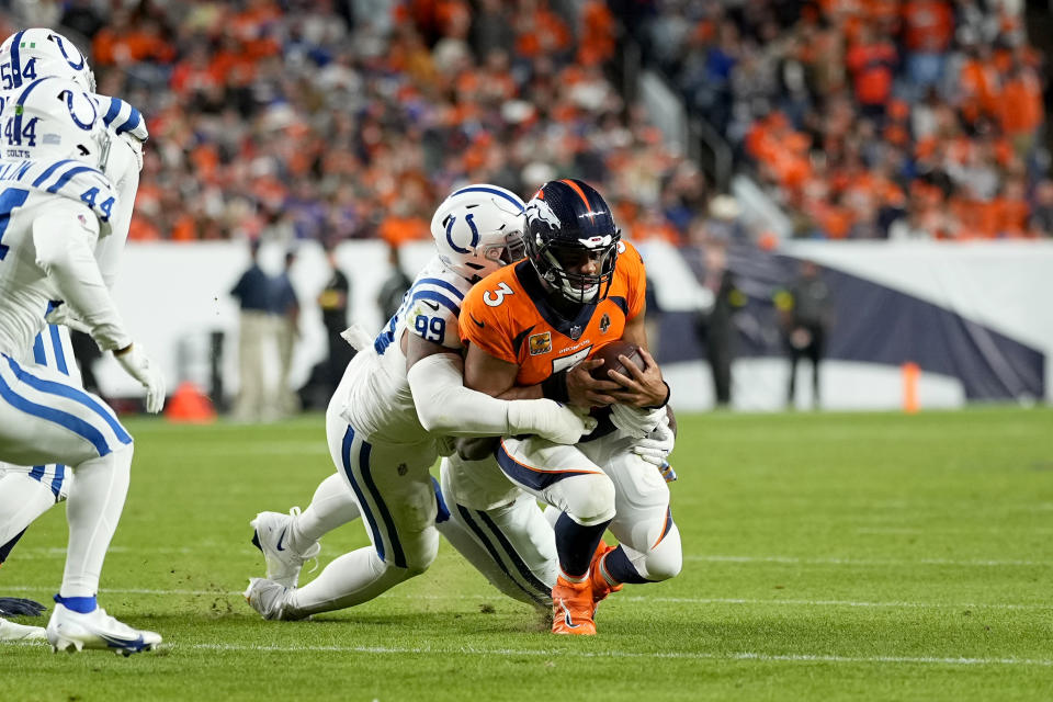 Denver Broncos quarterback Russell Wilson (3) is tackled by Indianapolis Colts defensive tackle DeForest Buckner (99) during the second half of an NFL football game, Thursday, Oct. 6, 2022, in Denver. (AP Photo/Jack Dempsey)