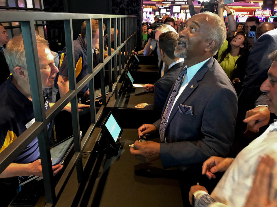 State Assemblyman Gary Pretlow, D-Westchester County, places a bet at Rivers Casino and Resort, Tuesday, July 16, 2019, in Schenectady, N.Y. New York joined the growing list of states allowing wagering on sports after the upstate casino cut the ribbon on a new betting lounge Tuesday and took its first bet — $20 on the Seattle Mariners. (AP Photo/David Klepper)