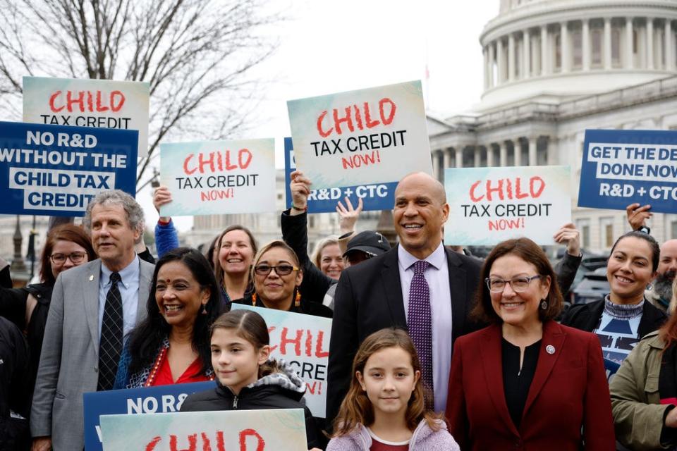 Senator Sherrod Brown, D-Ohio,  Senator Cory Booker, D-N.J., and Representative Suzan DelBene, D-Wash., with supporters during Press Briefing With U.S. House And Senate Champions, Impacted Families on Expanding the Child Tax Credit During Lame Duck Session on December 07, 2022 in Washington, DC.