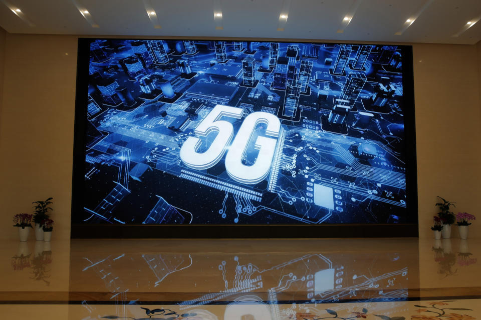 In this March 6, 2019, photo, a 5G logo is displayed on a screen outside the showroom at Huawei campus in Shenzhen city, China's Guangdong province. Australia’s ban on Chinese telecoms giant Huawei’s involvement in its future 5G networks and its crackdown on foreign covert interference are testing Beijing’s efforts to project its power overseas. In its latest maneuver, China sent three scholars to spell out in interviews with Australian media and other appearances steps to mend the deepening rift with Beijing - a move that appears to have fallen flat. (AP Photo/Kin Cheung, File)