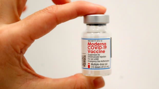 A healthcare worker holds a vial of the Moderna COVID-19 Vaccine