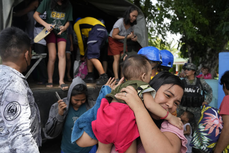 Residents arrive on a military truck at an evacuation center in Santo Domingo town, Albay province, northeastern Philippines, Tuesday, June 13, 2023. Truckloads of villagers on Tuesday fled from Philippine communities close to gently erupting Mayon volcano, traumatized by the sight of red-hot lava flowing down its crater and sporadic blasts of ash. (AP Photo/Aaron Favila)