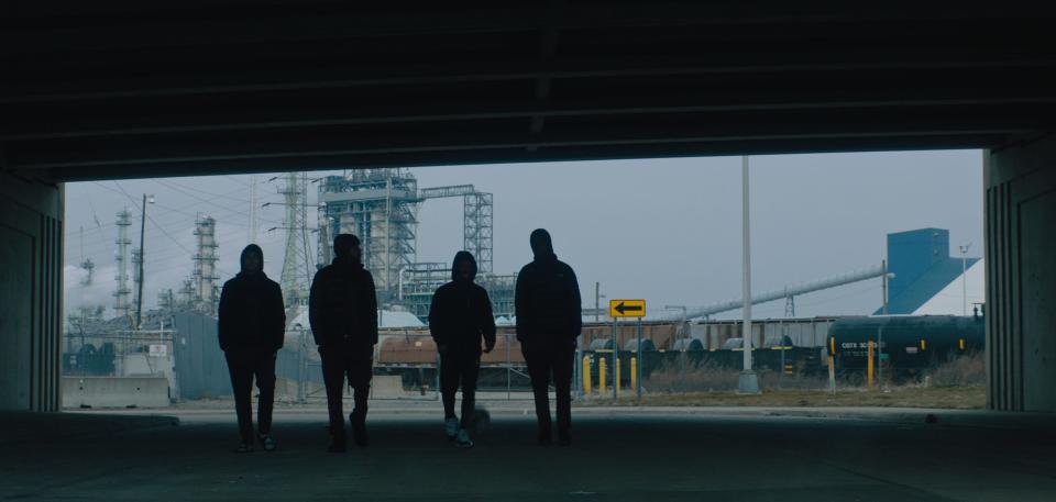 Four members of the River Rouge basketball team walk near Detroit's Marathon refinery in the documentary film "Rouge,” a coming-of-age basketball story set in River Rouge, a metro Detroit community with a rich basketball tradition and some present-day struggles. The film will make its Michigan premiere on opening night at the 11th annual Freep Film Festival.