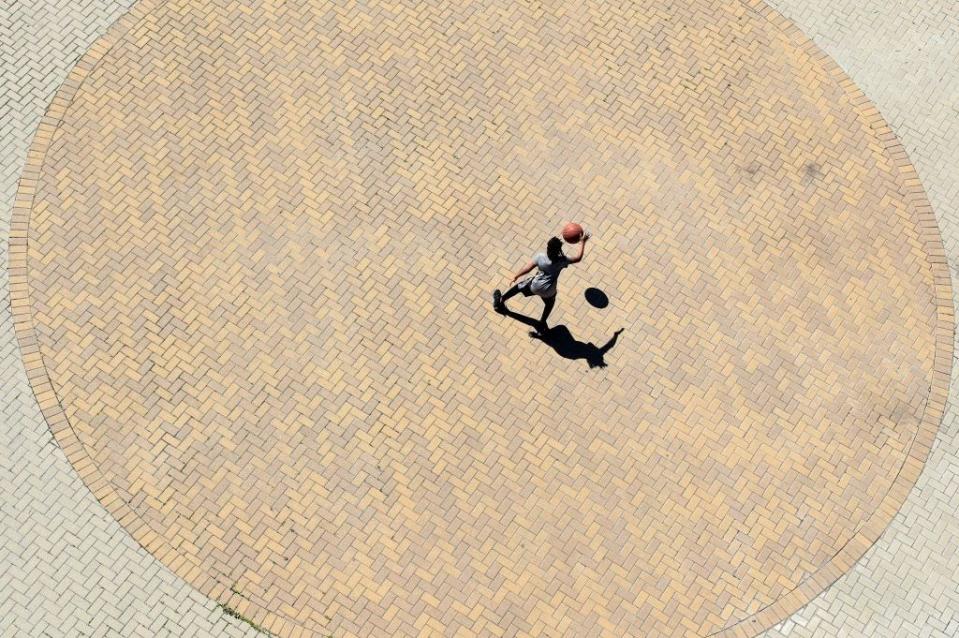 March 29: A child dribbles a basketball alone at Waterfront Park in downtown Louisville, Kentucky. (Getty Images)