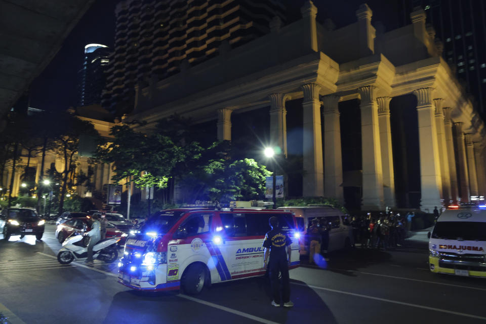 An ambulance sits outside the Grand Hyatt Erawan Hotel to Chulalongkorn hospital in Bangkok, Thailand, Tuesday, July 16, 2024. Police say the bodies of six people were found in the luxury hotel in downtown Bangkok. (AP Photo/Chatkla Samnaingjam)