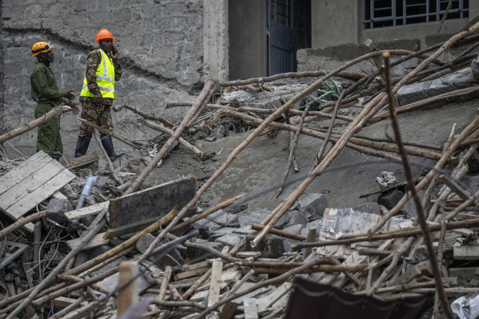 Personnel from the Kenya Defence Forces disaster response unit examine the scene of a building collapse in the Kasarani neighborhood of Nairobi, Kenya Tuesday, Nov. 15, 2022. Workers at the multi-storey residential building that was under construction are feared trapped in the rubble and rescue operations have begun, but there was no immediate official word on any casualties. (AP Photo/Ben Curtis)