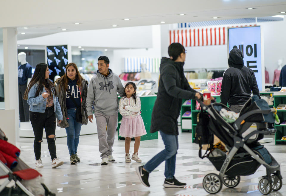 Ecuadorian migrant Klever Ortega, second from right, visits the American Dream mall with his wife, Cristina Lema, second from left, and two daughters, Josselyn, far left, and Danna, 8, Saturday, March. 3, 2023, in East Rutherford, N.J. Ecuador — long known for remarkably low rates of crime, despite sitting in South America's cocaine heartland — has been struggling economically, fighting higher violence and losing its people in record numbers. Like the Ortegas, many are headed to the U.S.(AP Photo/Eduardo Munoz Alvarez)