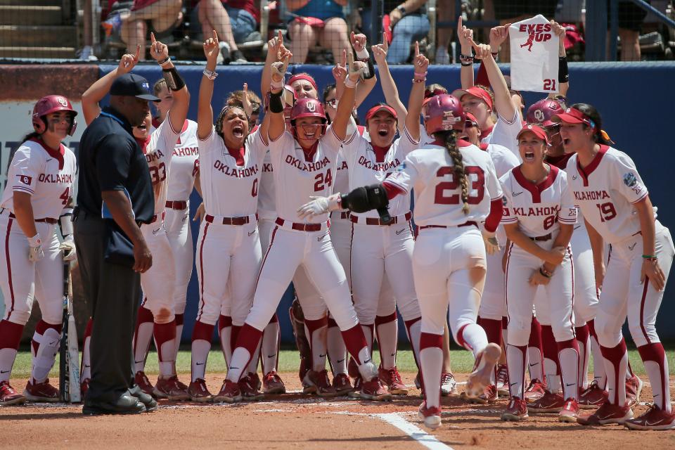 Oklahoma's Tiare Jennings (23) is greeted at home after hitting a three-run home run in the second inning of a softball game between the University of Oklahoma Sooners (OU) and Tennessee in the Women's College World Series at USA Softball Hall of Fame Stadium in Oklahoma City, Saturday, June 3, 2023. 