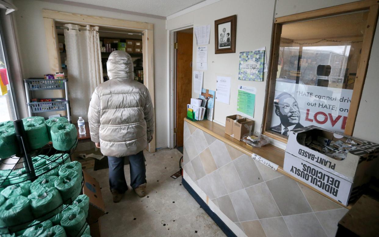 A resident stands in the pantry area Thursday, Feb. 9, 2023, at Motels4Now at the Knights Inn on Lincoln Way West in South Bend.
