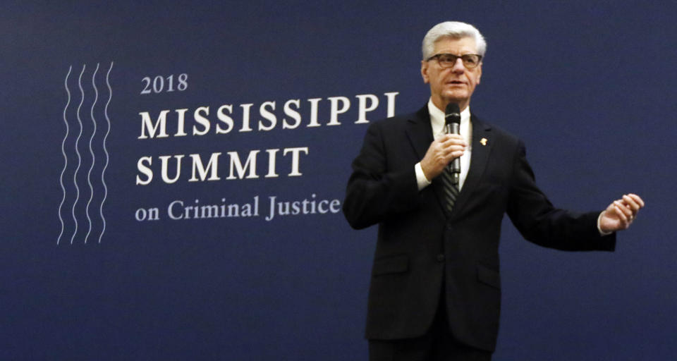 Gov. Phil Bryant says he'll support efforts to reduce the number of Mississippians in prison in the 2019 legislative session during a discussion on criminal justice reform, at the Mississippi Summit on Criminal Justice Reform in Jackson, Miss., Tuesday, Dec. 11, 2018. The meeting was put on by a coalition of groups that favor changes to reduce harshness in the criminal justice system. (AP Photo/Rogelio V. Solis)