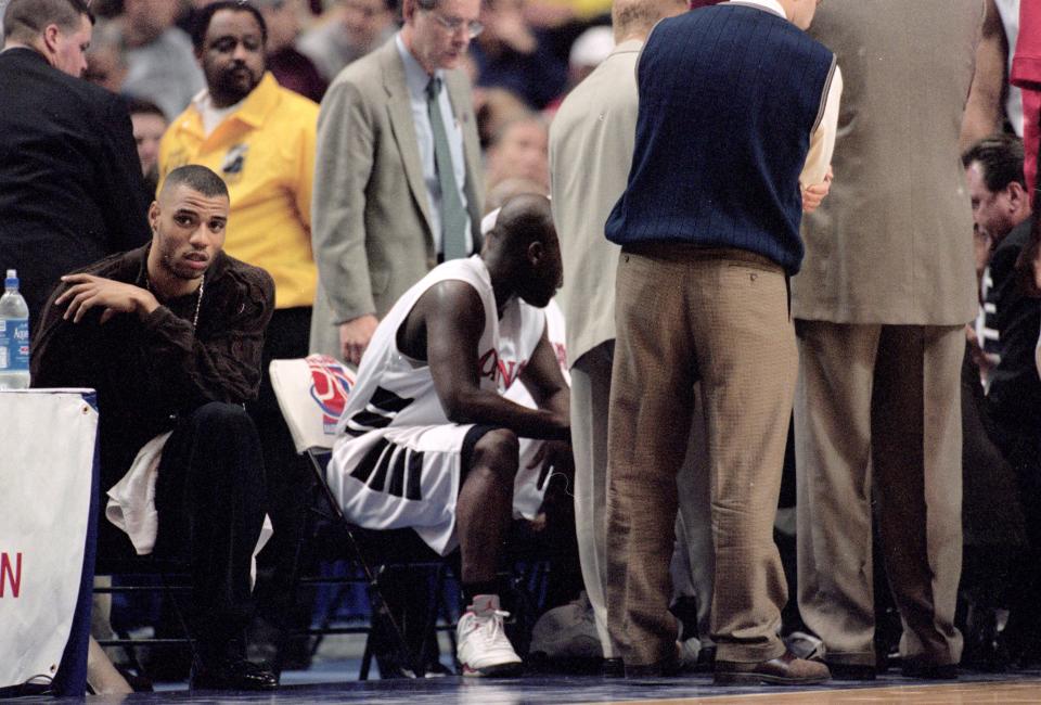 Kenyon Martin (L) of Cincinnati Bearcats sits on the bench during round one of the NCAA tournament game against the NC Wilmington Seahawks. (Jonathan Daniel/Allsport)