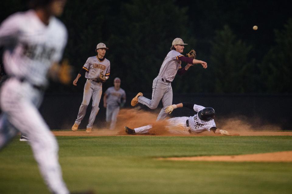 Lumberton's Garret Smith forces out Gray's Creek's Ryan Smith and throws for an attempted double play during the third inning on Tuesday, April 18, 2023, at Gray's Creek High School.