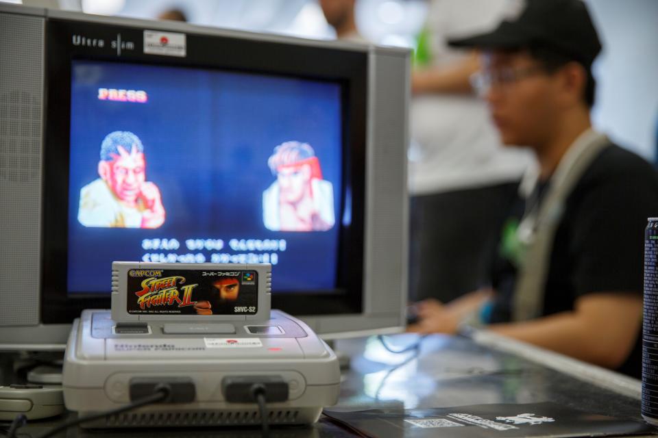 This photo taken on August 12, 2017 shows a Nintendo Super Famicom, a 1990s era 16-bit console that was marketed outside Japan as the Super NES (Nintendo Entertainment System), running the hit Capcom beat 'em up game Street Fighter II on a cathode ray tube television, at a retro gaming expo in Hong Kong. - A group of Japanese retro video game enthusiasts on April 28, 2020 are hoping that lockdown-induced boredom will convert today's teens into fans of yesteryear's games, offering 100 classic Nintendo consoles to cooped-up kids. (Photo by TENGKU Bahar / AFP) (Photo by TENGKU BAHAR/AFP via Getty Images)