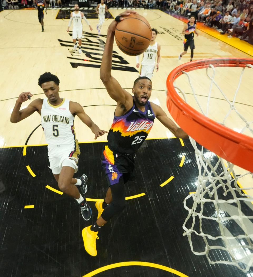 Apr 19, 2022; Phoenix, Arizona, U.S.;  Phoenix Suns forward Mikal Bridges (25) dunks in front of New Orleans Pelicans forward Herbert Jones (5) during Game 2 of the Western Conference playoffs.
