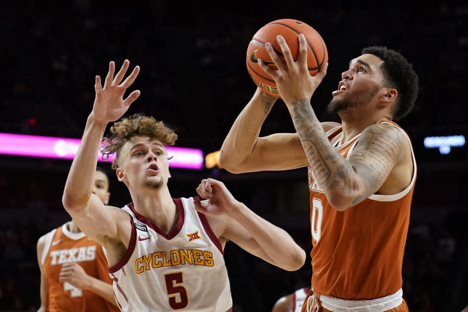 Texas forward Timmy Allen (0) drives to the basket ahead of Iowa State forward Aljaz Kunc (5) during the second half of an NCAA college basketball game, Saturday, Jan. 15, 2022, in Ames, Iowa. (AP Photo/Charlie Neibergall)