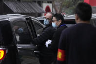 Peter Ben Embarek of the World Health Organization team, center left, leaves after a field visit at the Service Center for Party Members and Residents of Jiangxinyuan Community in Wuhan in central China's Hubei province on Thursday, Feb. 4, 2021. (AP Photo/Ng Han Guan)