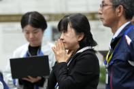 Staff of Japan Aerospace Exploration Agency (JAXA) watch a live streaming of the pinpoint moon landing operation by the Smart Lander for Investigating Moon (SLIM) spacecraft at JAXA's Sagamihara Campus Saturday, Jan. 20, 2024, in Sagamihara near Tokyo. Japan's space agency said early Saturday that its spacecraft is on the moon, but is still "checking its status." More details will be given at a news conference, officials said. (AP Photo/Eugene Hoshiko)