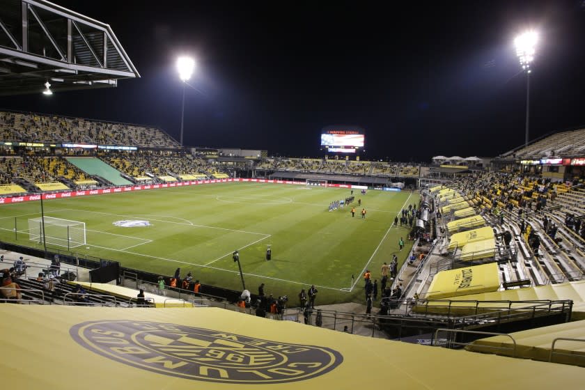 Seattle Sounders and Columbus Crew players line up for the national anthem before the MLS Cup championship soccer match Saturday, Dec. 12, 2020, in Columbus, Ohio. (AP Photo/Jay LaPrete)