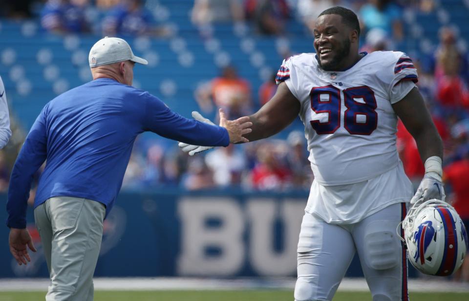 Bills defensive tackle C.J. Brewer (98) gets a high-five from head coach Sean McDermott as he walks off the field after a big third down stop late in the second half of the Bills preseason game against Denver Saturday, Aug. 20, 2022 at Highmark Stadium.