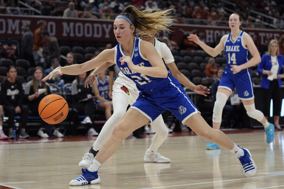 Drake guard Ava Hawthorne (21) loses control of the ball as she drives to the basket during the second half of a first-round college basketball game against Louisville in the NCAA Tournament in Austin, Texas, Saturday, March 18, 2023. (AP Photo/Eric Gay)