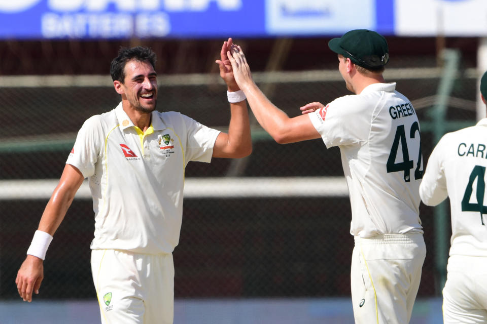 Pictured left, Australia's Mitchell Starc celebrates with teammate Cameron Green after the dismissal of Hasan Ali during the third day of the second Test against Pakistan. 