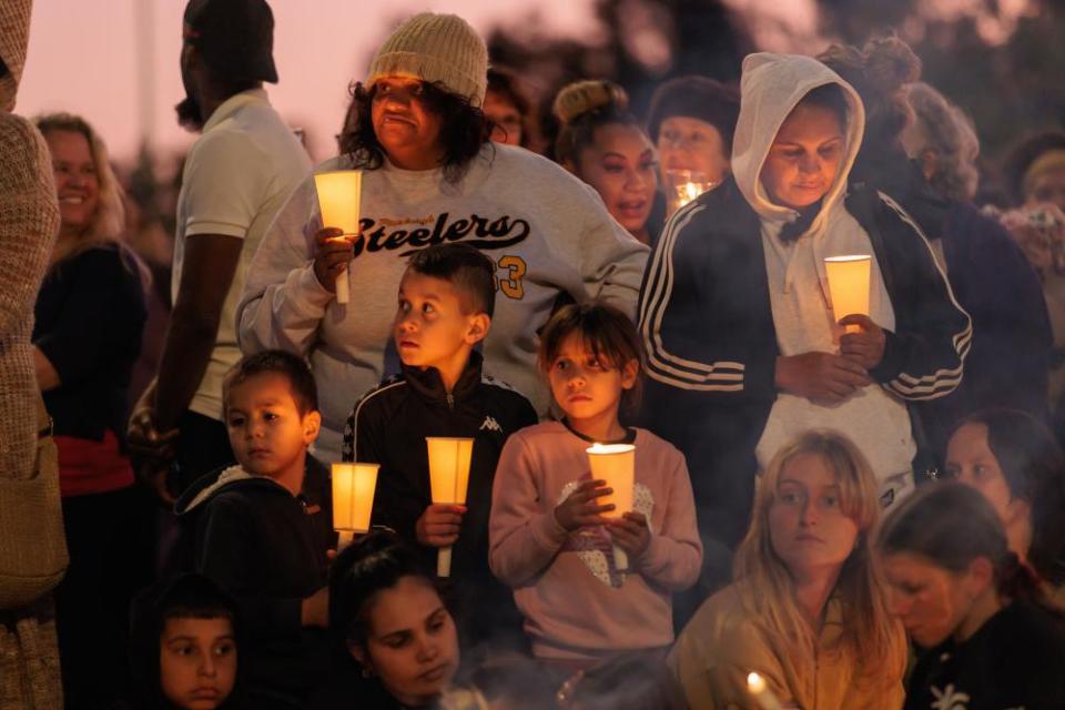 Family, friends and members of the public gather during a vigil for Cassius Turvey at Midland Oval in Perth