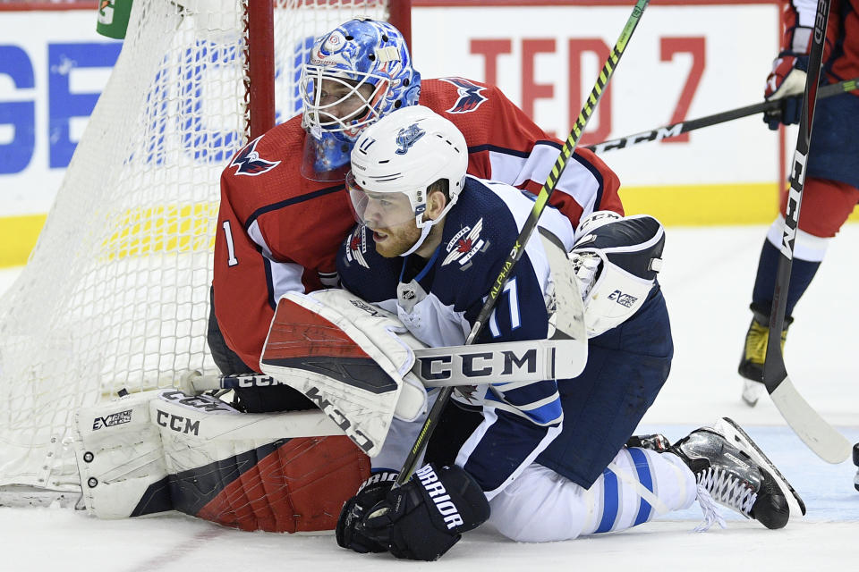 Washington Capitals goaltender Pheonix Copley (1) battles with Winnipeg Jets center Adam Lowry (17) during the second period of an NHL hockey game, Sunday, March 10, 2019, in Washington. The Capitals won 3-1. (AP Photo/Nick Wass)