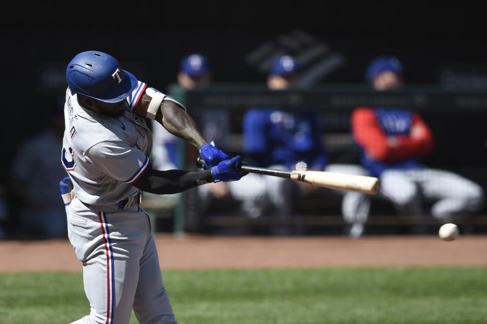 Texas Rangers Adolis Garcia connects for a single against the Baltimore Orioles in the first inning of a baseball game Sunday, Sept. 26, 2021, in Baltimore. (AP Photo/Gail Burton)