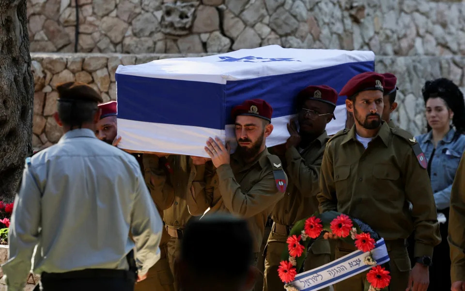 Israeli soldiers carry the casket during the funeral of Israeli reserve soldier Master sergeant Tzvika Lavi