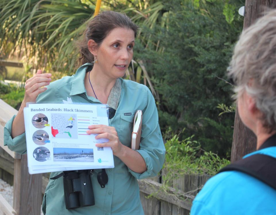 Dr. Abby Sterling shows a page from the bird ambassadors informational flip book.