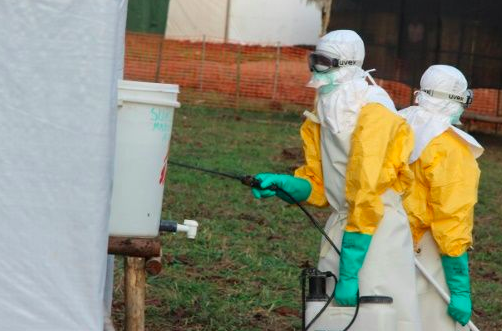 Hygienists wearing protective suits disinfect the toilets of an Ebola treatment centre in DR Congo during an earlier outbreak. Source: AFP